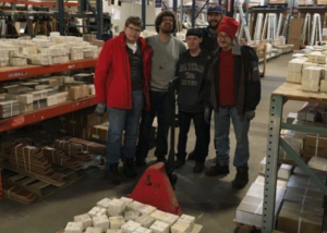 Goodwill trainees stocking tile aisle, 2018.