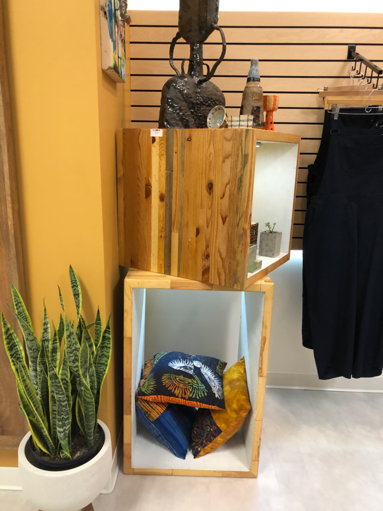 Finished reclaimed door display cubes filled with items for sale at the grand opening of Argyle Studio.