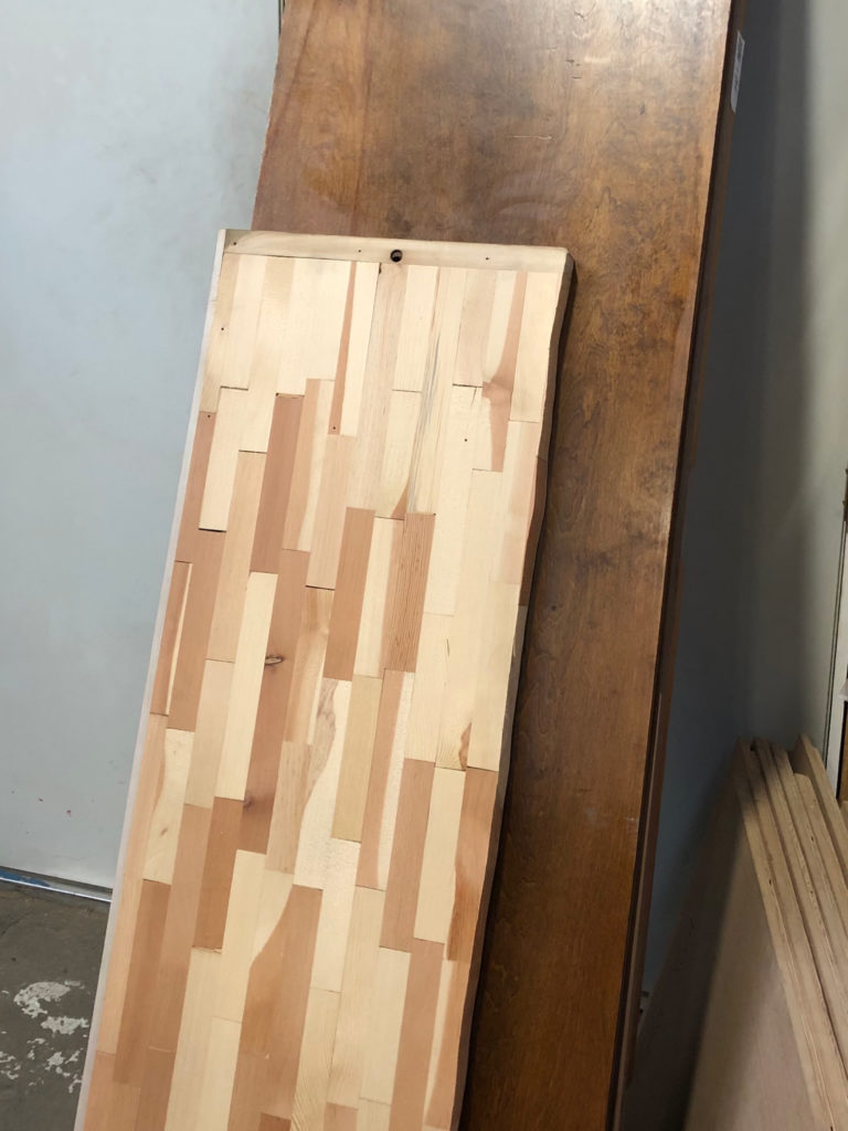 The planed commercial door core in front of an unplaned door.