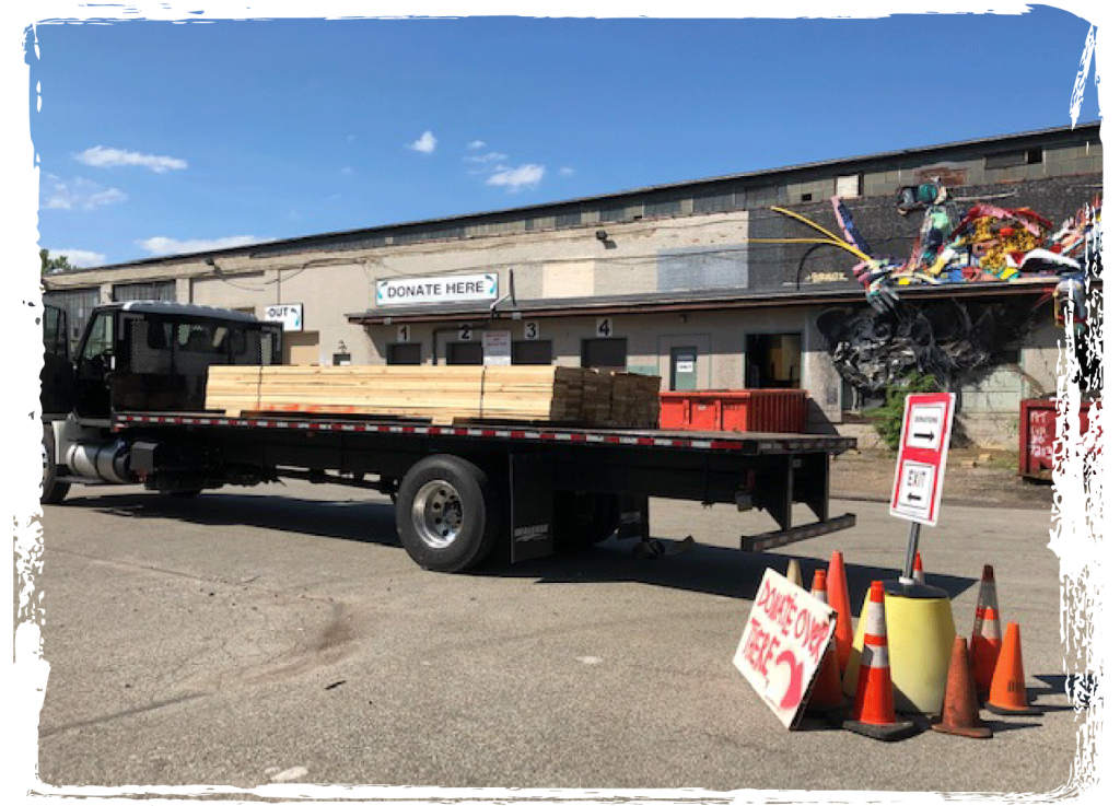 Flatbed truck loaded with reclaimed lumber at CJ