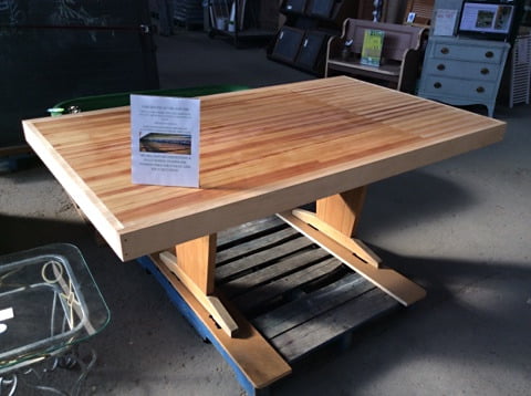 Reclaimed bowling lane wood table with rich multi-toned striped top and rustic lower shelf
